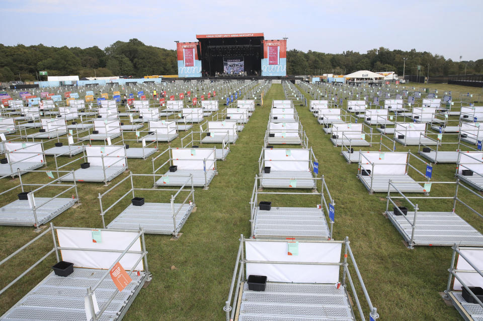 Preparations are underway ahead of the Sam Fender music concert at the Virgin Money Unity Arena, a pop-up venue for the gig in Gosforth Park, Newcastle, northern England, Tuesday Aug. 11, 2020.  Fans in groups of up to five people will watch the show from 500 separate raised metal platforms at what the promoters say is the world's first socially-distanced COVID-19 gig. (Owen Humphreys/PA via AP)