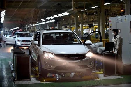 Employees work at a production line inside an automobile factory in Hangzhou, Zhejiang Province, China, January 18, 2016. Picture taken January 18. REUTERS/Stringer ATTENTION EDITORS - THIS PICTURE WAS PROVIDED BY A THIRD PARTY. THIS PICTURE IS DISTRIBUTED EXACTLY AS RECEIVED BY REUTERS, AS A SERVICE TO CLIENTS. CHINA OUT. NO COMMERCIAL OR EDITORIAL SALES IN CHINA. - RTX22YOQ