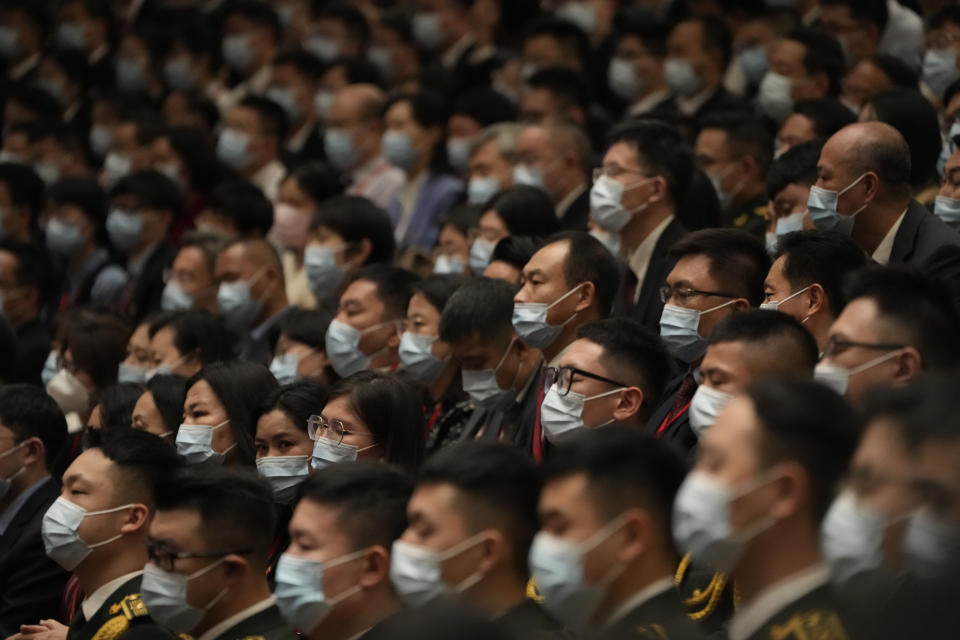 Delegates wearing masks attend the opening ceremony of the 20th National Congress of China's ruling Communist Party held at the Great Hall of the People in Beijing, China, Sunday, Oct. 16, 2022. China on Sunday opens a twice-a-decade party conference at which leader Xi Jinping is expected to receive a third five-year term that breaks with recent precedent and establishes himself as arguably the most powerful Chinese politician since Mao Zedong. (AP Photo/Mark Schiefelbein)