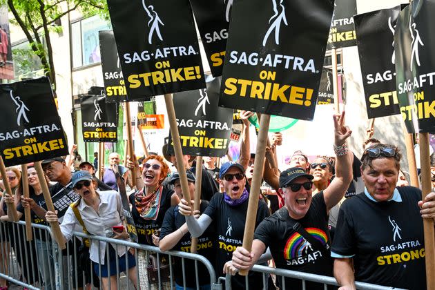 Members of the WGA and SAG-AFTRA picket outside Rockefeller Center.