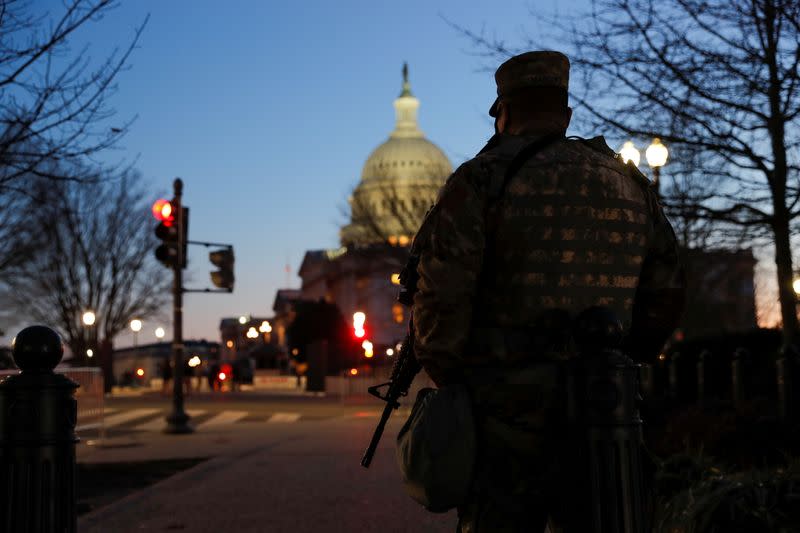 A member of the U.S. National Guard stands guard near the U.S. Capitol Building on Capitol Hill in Washington