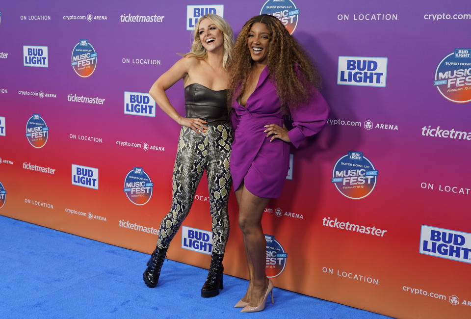 Lindsay Ell, left, and Mickey Guyton arrive at day two of the Bud Light Super Bowl Music Fest on Friday, Feb. 11, 2022, at Crypto.com Arena in Los Angeles. (AP Photo/Chris Pizzello)