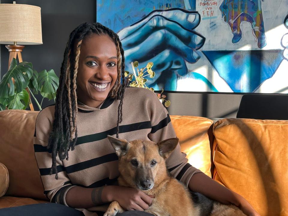 Renee Parker Sekander sits with her dog Miss Fox in her Crosstown Concourse apartment.