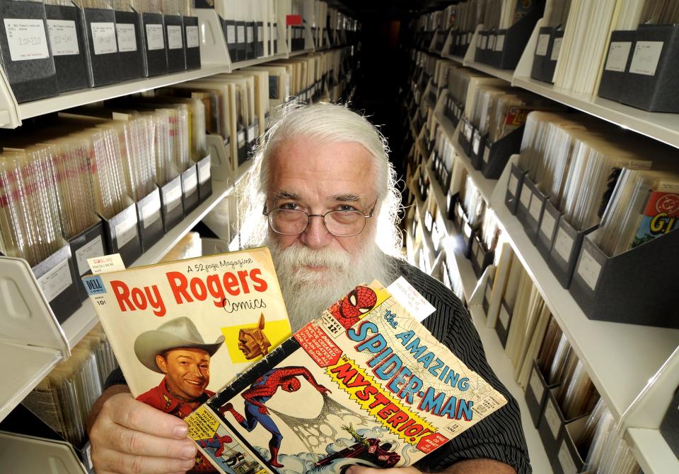 Randy Scott, comic art bibliographer at MSU, shows a Roy Rogers comic from 1953 and a Spiderman comic from  1964, part of  MSU's huge comic book collection in the Special Collections area at the MSU Library Monday August 24, 2009.