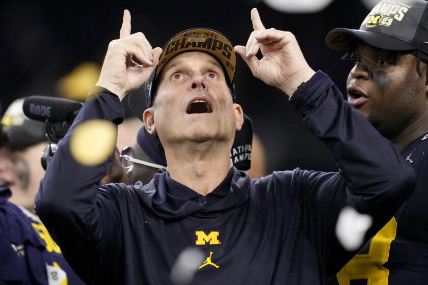 Michigan head coach Jim Harbaugh celebrates after their win against Washington.