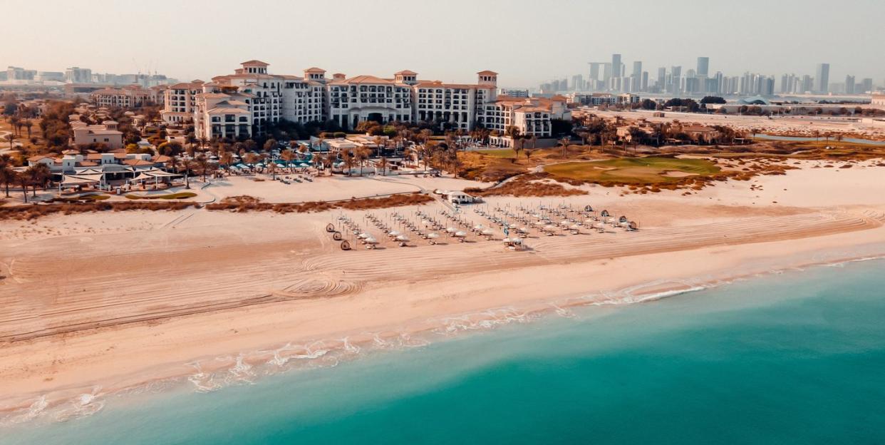 a beach with buildings in the background