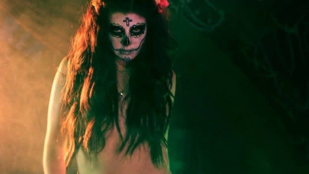 A woman in Día de los Muertos makeup