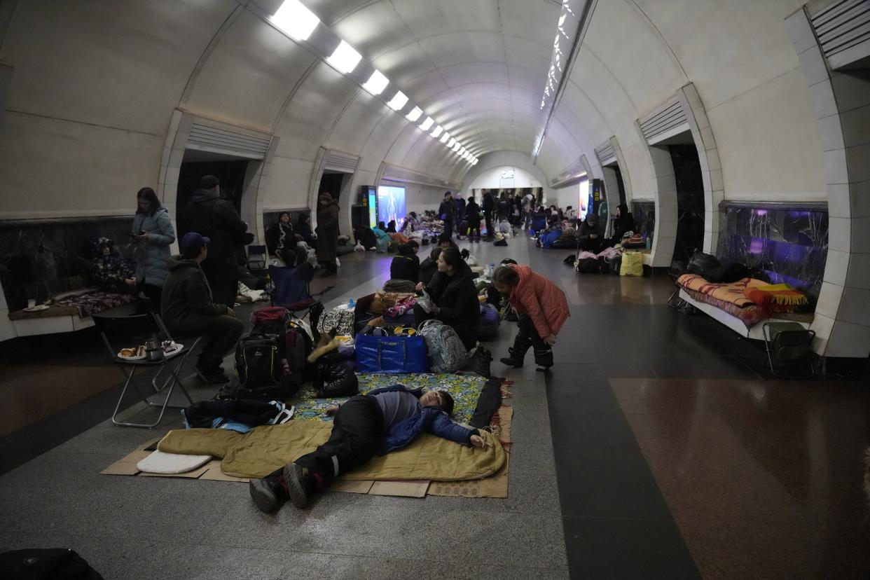 People gather in the Kyiv subway, using it as a bomb shelter in Kyiv, Ukraine, Wednesday, March 2, 2022. Russian forces have escalated their attacks on crowded cities in what Ukraine's leader called a blatant campaign of terror.
