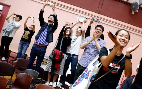 Supporters of local candidate Kelvin Lam celebrate his victory - Credit: REUTERS/Thomas Peter