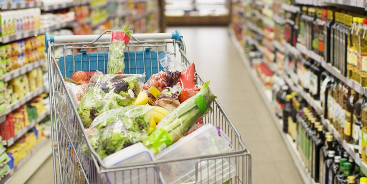 Close up of full shopping cart in grocery store