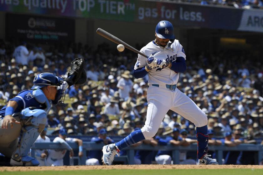 Los Angeles Dodgers' Mookie Betts, right, is hit by a pitch as Kansas City Royals.