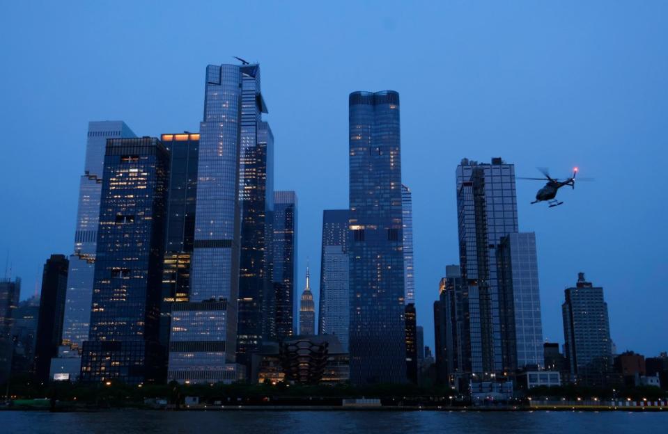 A helicopter prepares to land at the 30th Street heliport in front of Hudson Yards and the Empire State Building in Manhattan on May 22, 2023. Getty Images