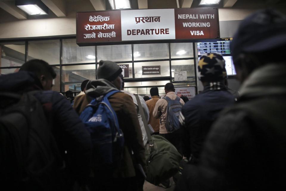 In this Tuesday, Nov. 22, 2016 photo, Nepali workers stand in queues at the departure gate for migrant workers at Tribhuwan International Airport in Kathmandu, Nepal. About 10 percent of Nepal's 28 million residents are working abroad. They send back more than $6 billion a year, amounting to about 30 percent of the country's annual revenues. Only Tajikistan and Kyrgyzstan are more dependent on foreign earnings. (AP Photo/Niranjan Shrestha)