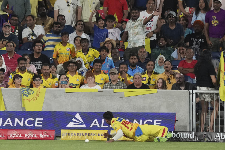 Texas Super Kings fielder Milind Kumar stops the ball at the boundary during the team's Major League Cricket match against the Los Angeles Knight Riders in Grand Prairie, Texas, Thursday, July 13, 2023. (AP Photo/LM Otero)