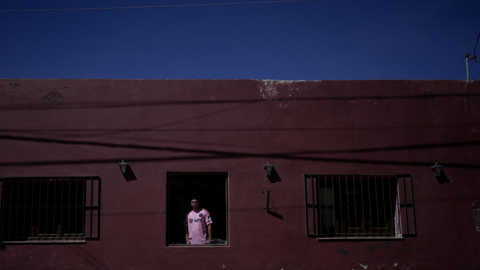 Elías Agustín Rivero poses at the restaurant owned by his parents where he works in San Antonio de los Cobres, Salta, Argentina, Tuesday, Oct. 3, 2023. Rivero supports presidential candidate Javier Milei in part because he thinks a Milei presidency would lead to more jobs for young people. (AP Photo/Natacha Pisarenko)