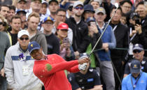 U.S. team player and captain Tiger Woods watches his sceond shot on the 7th hole as the turf flies up during their fourball match at the Royal Melbourne Golf Club in the opening rounds of the President's Cup golf tournament in Melbourne, Thursday, Dec. 12, 2019. (AP Photo/Andy Brownbill)