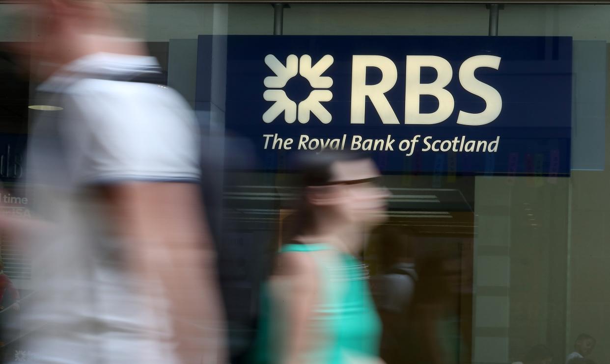 Pedestrians pass a branch of a Royal Bank of Scotland (RBS) bank branch in central London on July 25, 2018. (Photo by Daniel LEAL-OLIVAS / AFP)        (Photo credit should read DANIEL LEAL-OLIVAS/AFP/Getty Images)