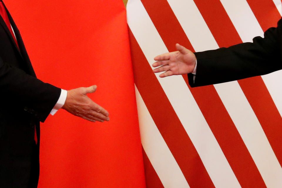 U.S. President Donald Trump and China's President Xi Jinping shake hands after making joint statements at the Great Hall of the People in Beijing, China, November 9, 2017. Damir Sagolj: "It's one of those "how to make a better or at least different shot when two presidents shake hands several times a day, several days in row". If I'm not mistaken in calculation, presidents Xi Jinping of China and Donald Trump of the U.S. shook their hands at least six times in events I covered during Trump's recent visit to China. I would imagine there were some more handshakes I haven't seen but other photographers did. And they all look similar - two big men, smiling and heartily greeting each other until everyone gets their shot. But then there is always something that can make it special - in this case the background made of U.S. and Chinese flags. They shook hands twice in front of it, and the first time it didn't work for me. The second time I positioned myself lower and centrally, and used the longest lens I have to capture only hands reaching for a handshake." REUTERS/Damir Sagolj/File Photo  SEARCH "POY TRUMP" FOR THIS STORY. SEARCH "REUTERS POY" FOR ALL BEST OF 2017 PACKAGES.    TPX IMAGES OF THE DAY