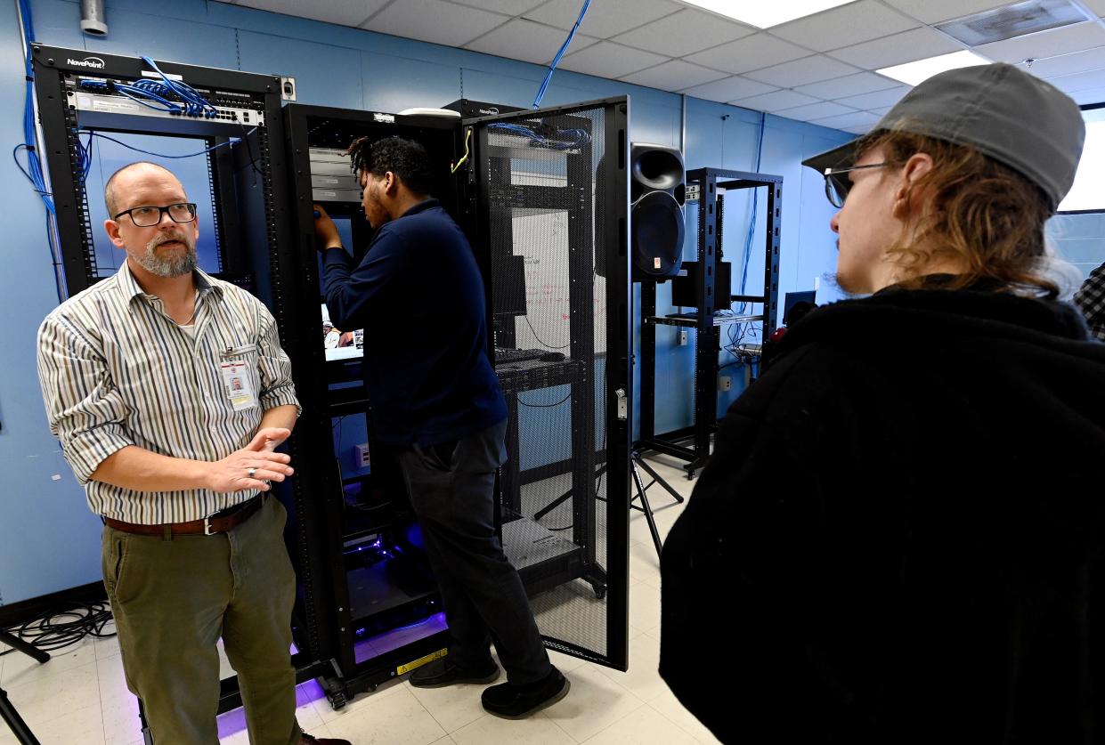 Instructor Joe Redemske talks with Max Rivers, 19, right, and Isaiah Bryant, 18, during a computer information technology class at the Tennessee College of Applied Technology. Redemske says classes at TCAT are also designed to teach soft skills such as customer service and office etiquette.