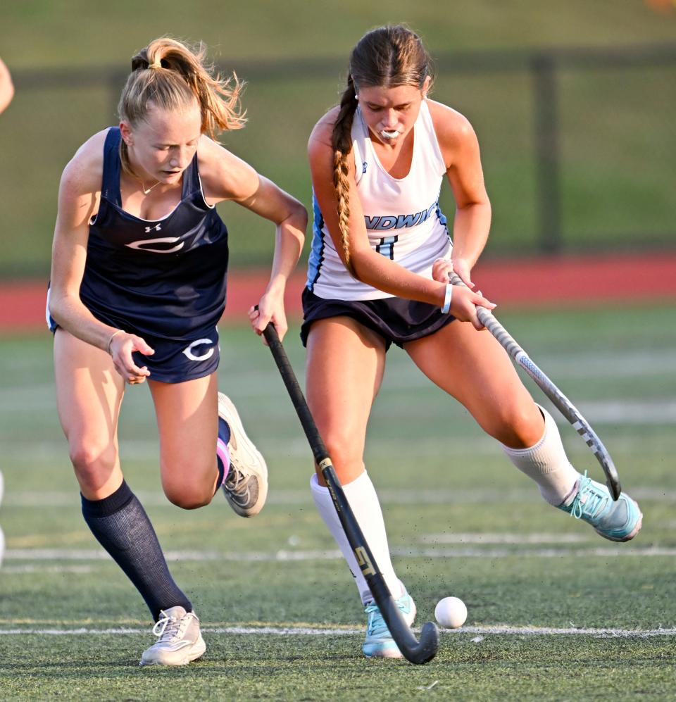 Khloe Schultz of Sandwich and Reese Hansen of Cohasset tangle while going after the ball.