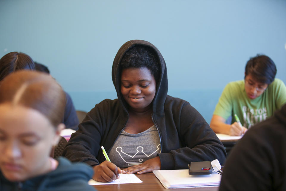 Boston Latin Academy student Tachenia Saintil, 16, works on a pre-calculus problem during the Bridge to Calculus summer program at Northeastern University in Boston on Tuesday, Aug. 1, 2023. (AP Photo/Reba Saldanha)