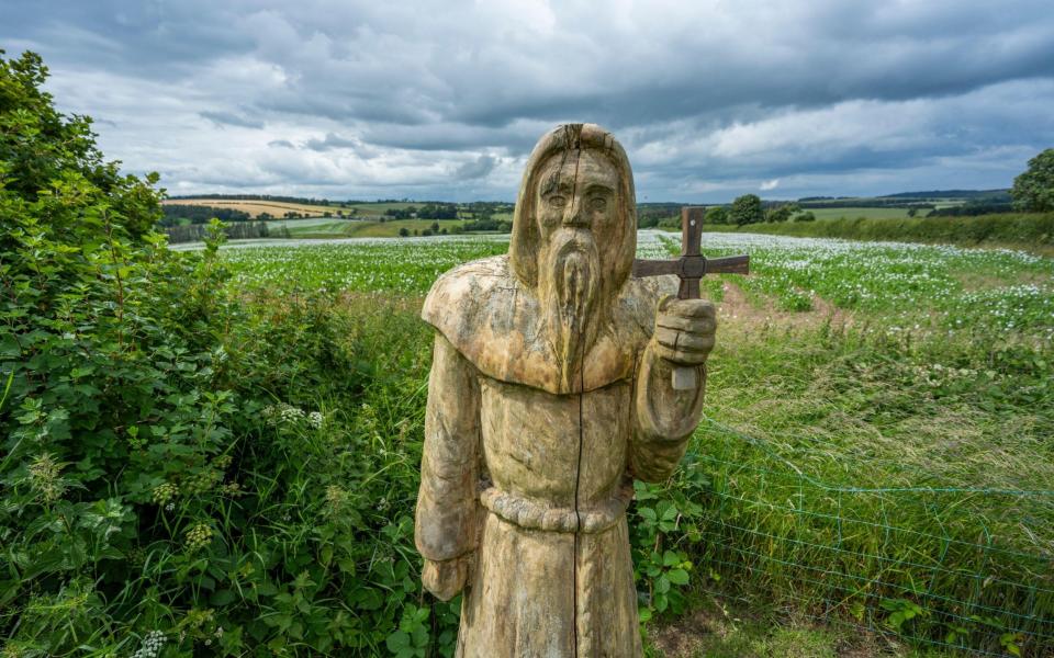 Wood carving of St Cuthbert on St Cutherbert's Way