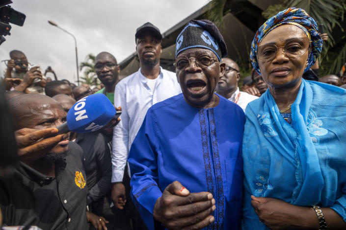 FILE - Presidential candidate Bola Tinubu, center, of the All Progressives Congress, accompanied by his wife Oluremi Tinubu, right, speaks to the media after casting his vote in the presidential elections in Lagos, Nigeria, Feb. 25, 2023. Election officials declared ruling party candidate Bola Tinubu the winner of Nigeria's presidential election early Wednesday, March 1, 2023, with the two leading opposition candidates already demanding a revote in Africa's most populous nation. (AP Photo/Ben Curtis, File)