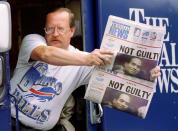 <p>Newspaper delivery truck driver Jim Janiszeski shows off the late edition of the Oct. 3, 1995, “Buffalo News” displaying the headline of the day, the verdict of not guilty for former Buffalo Bills star running back O.J .Simpson. (Photo: Joe Traver/Reuters) </p>