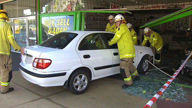 Fire fighters push car out of shop