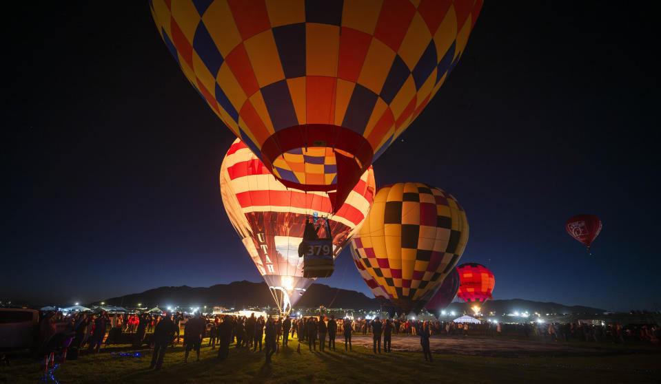 Balloonists begin to ascend for the start of the 51st Albuquerque International Balloon Fiesta in Albuquerque N.M., on Saturday, Oct. 7, 2023. (AP Photo/Roberto E. Rosales)