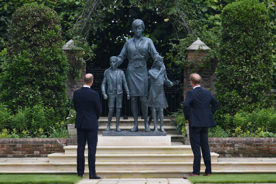 Prince William and Prince Harry look at the staue they commissioned of their mother Princess Diana,  on what woud have been her 60th birthday, in the Sunken Garden at Kensington Palace, London, Thursday July 1, 2021.