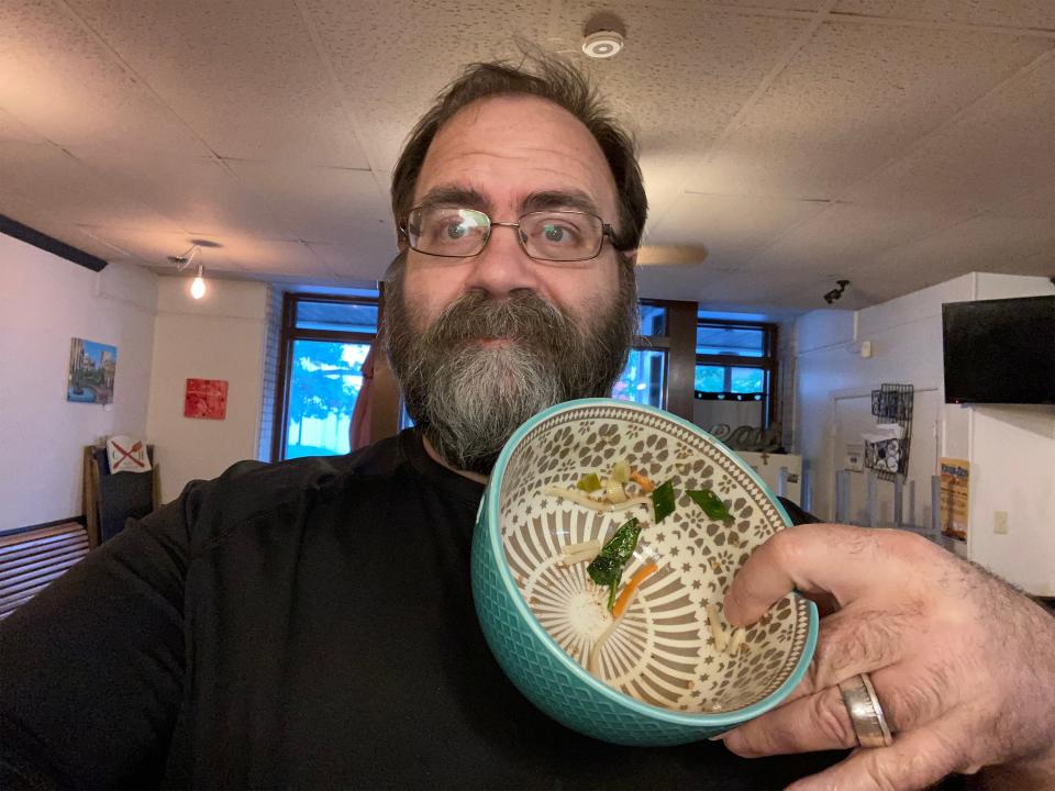 Montgomery Advertiser reporter Shannon Heupel, a first-time real ramen eater, shows his empty ramen bowl from Express Yo Noodle on Monday, May 1, 2023.