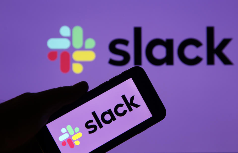 PARIS, FRANCE - FEBRUARY 06: In this photo illustration, the Slack logo is displayed on the screen of an Apple iPhone in front of a computer screen displaying a Slack logo on February 06, 2019 in Paris, France. Slack announced in a statement that it had 'confidentially' filed its file with the SEC for an IPO. Launched in 2014 in San Francisco, the US Enterprise Messaging boasts 10 million daily active users in more than 150 countries worldwide. (Photo by Chesnot/Getty Images)