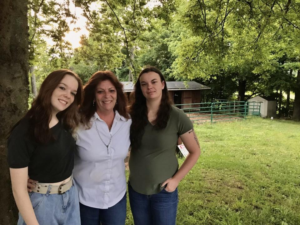 Dina McKenna and her two daughters, Sabrina and Katelynn, pose in front of their barn.