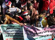 University students shout slogans during ongoing anti-government protests in Baghdad