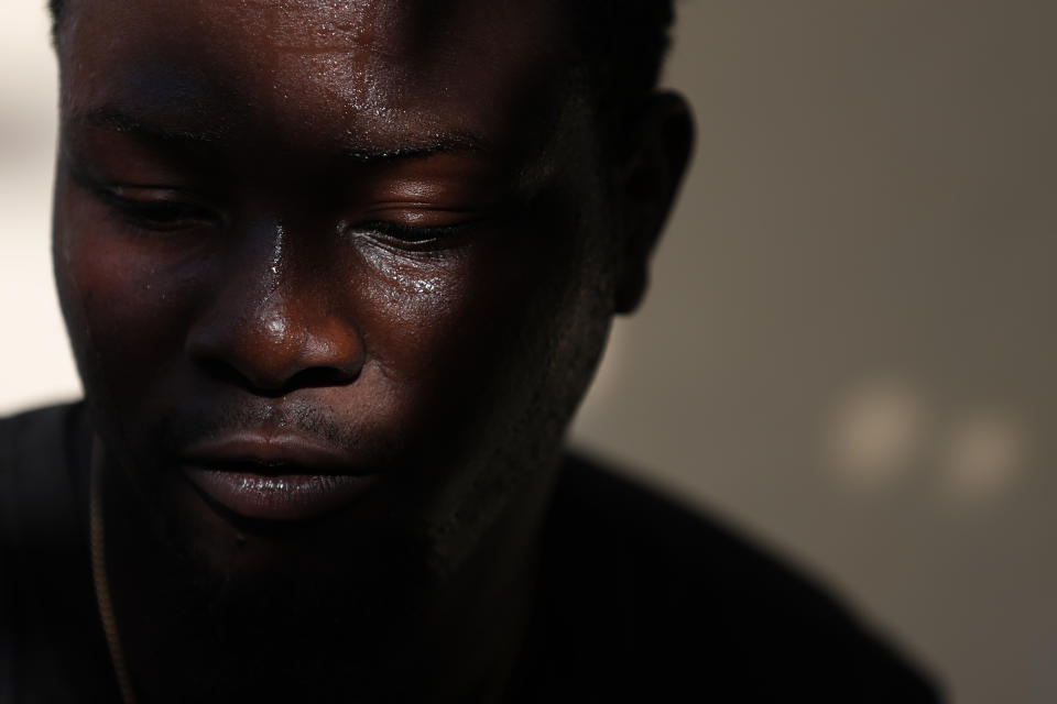 Entrepreneur and youth leader Pascéus Juvensky St. Fleur, 26, sits in the courtyard of his family home in the Delmas neighborhood of Port-au-Prince, Haiti, Tuesday, Oct. 8, 2019. St. Fleur says the protests are not only about replacing a president, but changing a system. "It's not one person, it's not the regime, it's not a president, it's not the opposition, it's not the bourgeoisie, but it's us who should do it," he said. "We dream of, and we want, a better Haiti."(AP Photo/Rebecca Blackwell)