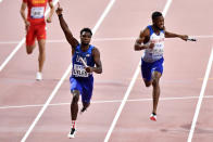 Noah Lyles of the United States crosses the finish line to win the men's 4x100 meter relay final ahead of silver medalist Nethaneel Mitchell-Blake of Great Britain & NI during the World Athletics Championships in Doha, Qatar, Saturday, Oct. 5, 2019. (AP Photo/Martin Meissner)