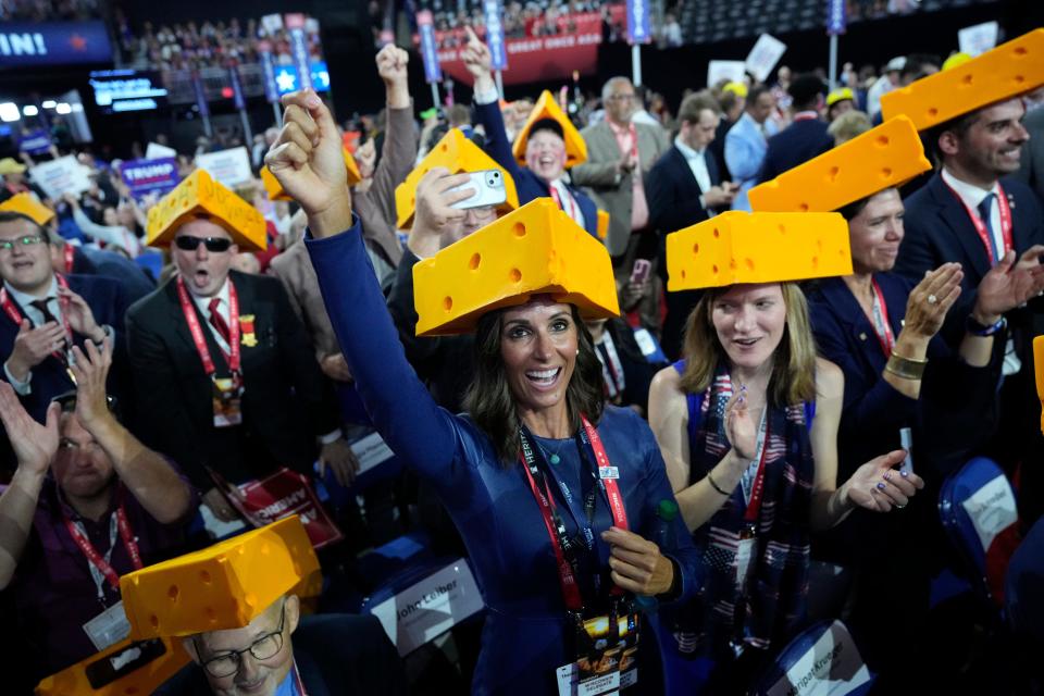 Wisconsin delegate Amber Schroeder of Mequon, Wisc. wears a cheesehead hat with other Wisconsin delegates as they cheer during the final day of the Republican National Convention at the Fiserv Forum. The final day of the RNC featured a keynote address by Republican presidential nominee Donald Trump.