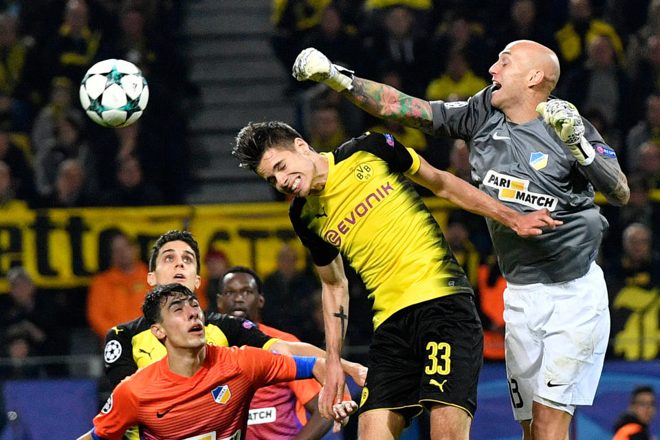 <p>Dortmund’s Julian Weigl, left center, jumps for the ball with APOEL’s goalkeeper Nauzet Perez during the Champions League group H soccer match between Borussia Dortmund and APOEL Nicosia in Dortmund, Germany, Wednesday, Nov. 1, 2017. (AP Photo/Martin Meissner) </p>