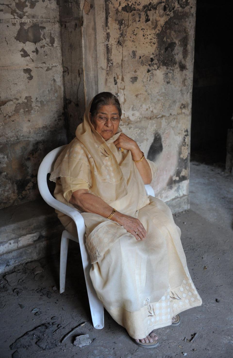 In this photograph taken on February 27, 2012 Zakia Jafri sits inside the remains of her former residence which was torched during the 2002 massacre at the Gulberg Society in Ahmedabad. (AFP via Getty Images)