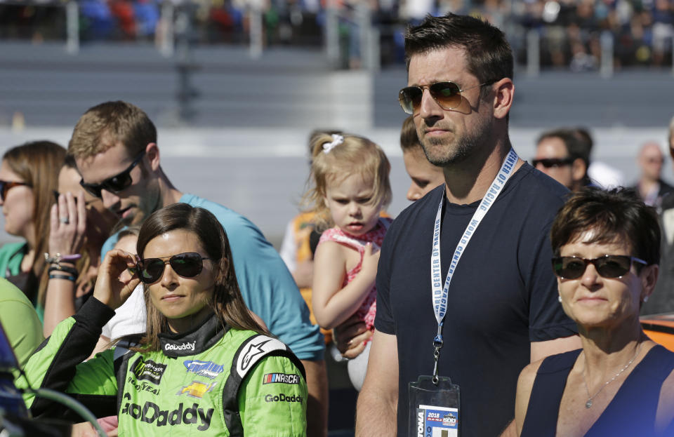 Danica Patrick, left, stands with Green Bay Packers quarterback Aaron Rodgers, right, before the NASCAR Daytona 500 Cup series auto race at Daytona International Speedway in Daytona Beach, Fla., Sunday, Feb. 18, 2018. (AP Photo/Terry Renna)