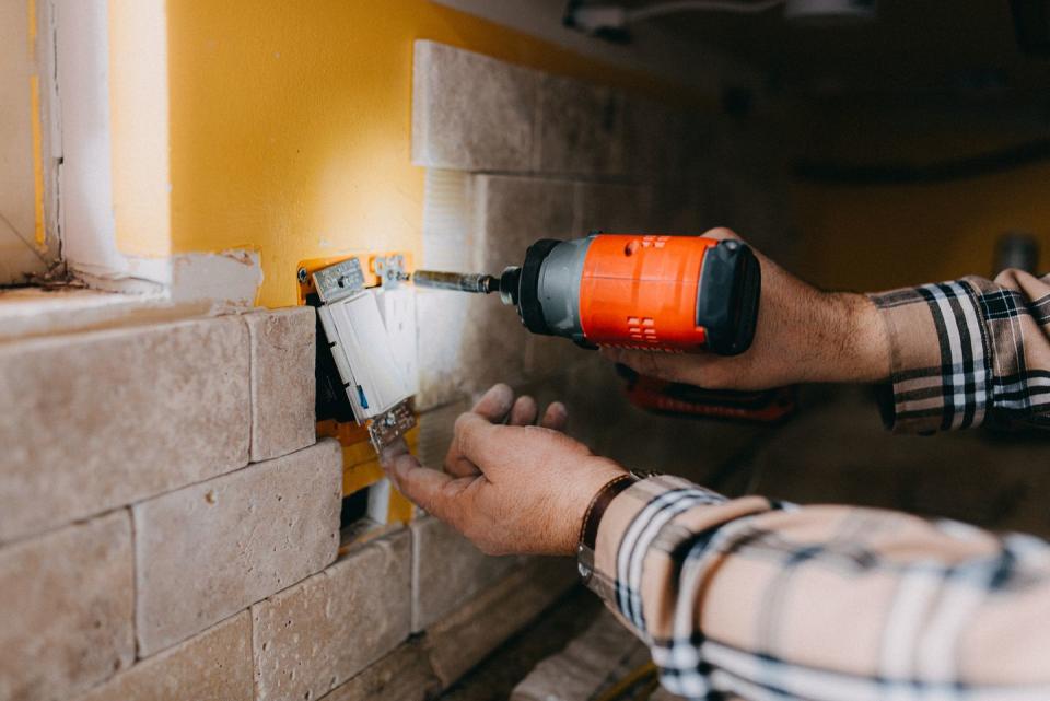 drilling light switch and power outlet into wall