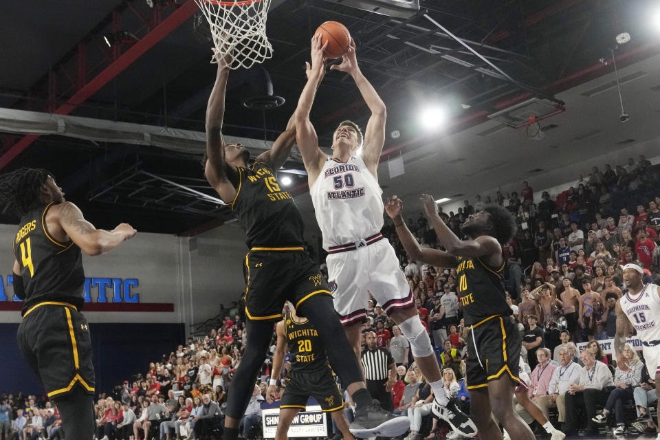 Florida Atlantic center Vladislav Goldin (50) drives to the basket as Wichita State center Quincy Ballard (15) defends during the first half of an NCAA college basketball game, Thursday, Jan. 18, 2024, in Boca Raton, Fla. (AP Photo/Marta Lavandier)