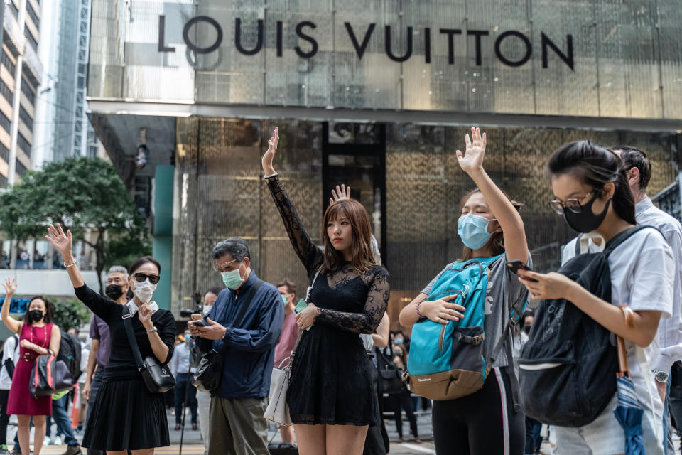 Pro-democracy supporters make gestures as they occupy a street in Central district on November 14, 2019 in Hong Kong, China. | Anthony Kwan—Getty Images