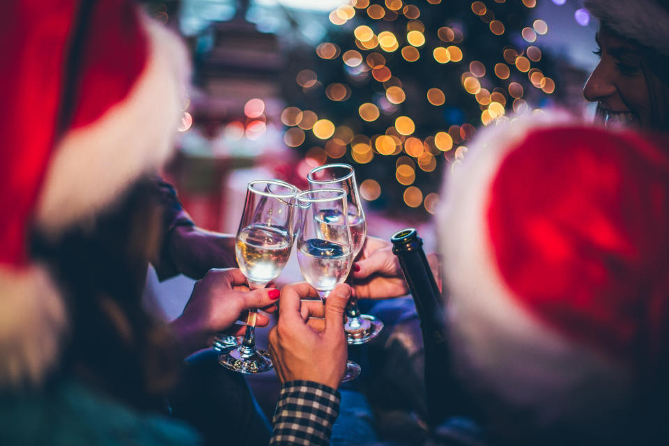 Celebrating Christmas holidays with a group of friends, toasting with champagne