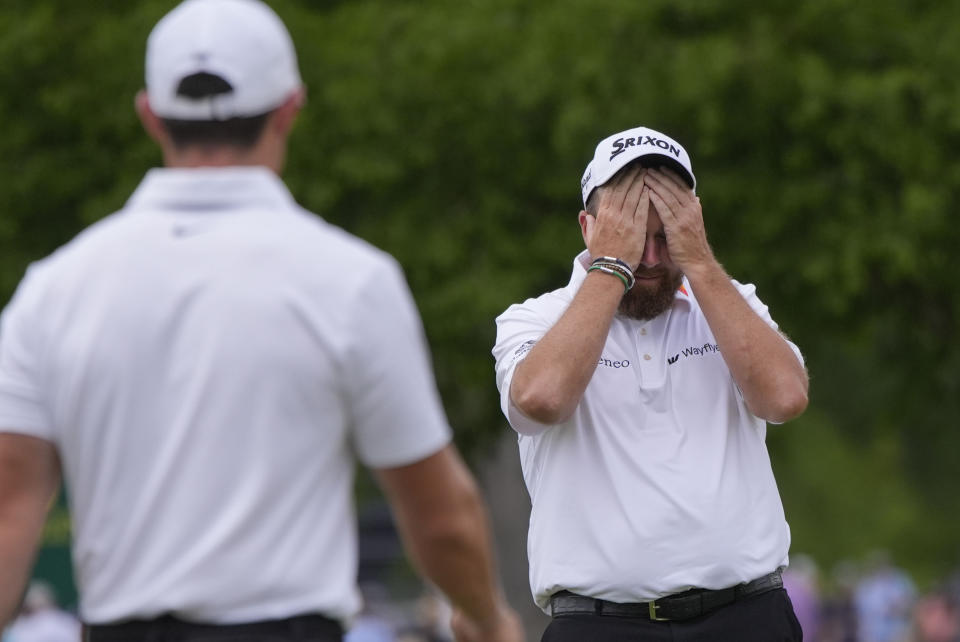 Rory McIlroy, of Northern Ireland, left, approaches teammate Shane Lowry, of Ireland, as he reacts after bogeying the third hole during the final round of the PGA Zurich Classic golf tournament at TPC Louisiana in Avondale, La., Sunday, April 28, 2024. (AP Photo/Gerald Herbert)