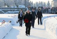 Russian President Vladimir Putin, center, takes part at a wreath laying ceremony at the Piskaryovskoye Cemetery, in St. Petersburg, Russia, Sunday, Jan. 27, 2019, where most of the Leningrad Siege victims were buried during World War II. The Russian city of St. Petersburg marked the 75th anniversary of the end of the World War II siege by Nazi forces. The siege of the city, then called Leningrad, lasted nearly two and a half years until the Soviet Army drove the Nazis away on Jan. 27, 1944. (Mikhail Klimentyev, Sputnik, Kremlin Pool Photo via AP)