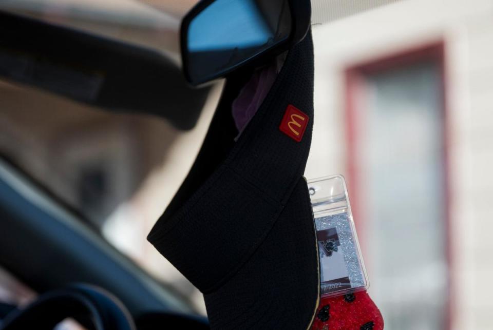Nikki Murray’s work hat hangs on her rearview mirror inside her car on Sunday, December 3, 2023 in Vernon. Murray, who works as a cashier at McDonald’s, attended Vernon College in the early 2000s but withdrew to raise her two kids while in an abusive relationship. College is still a dream for her, but she is currently settled in her job and continues to focus on caring for her family.