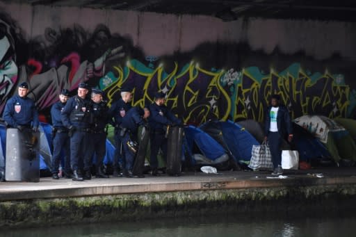 Security forces move in on the biggest migrant camp in the French capital where some 1,700 people lived in makeshift tents alongside a canal