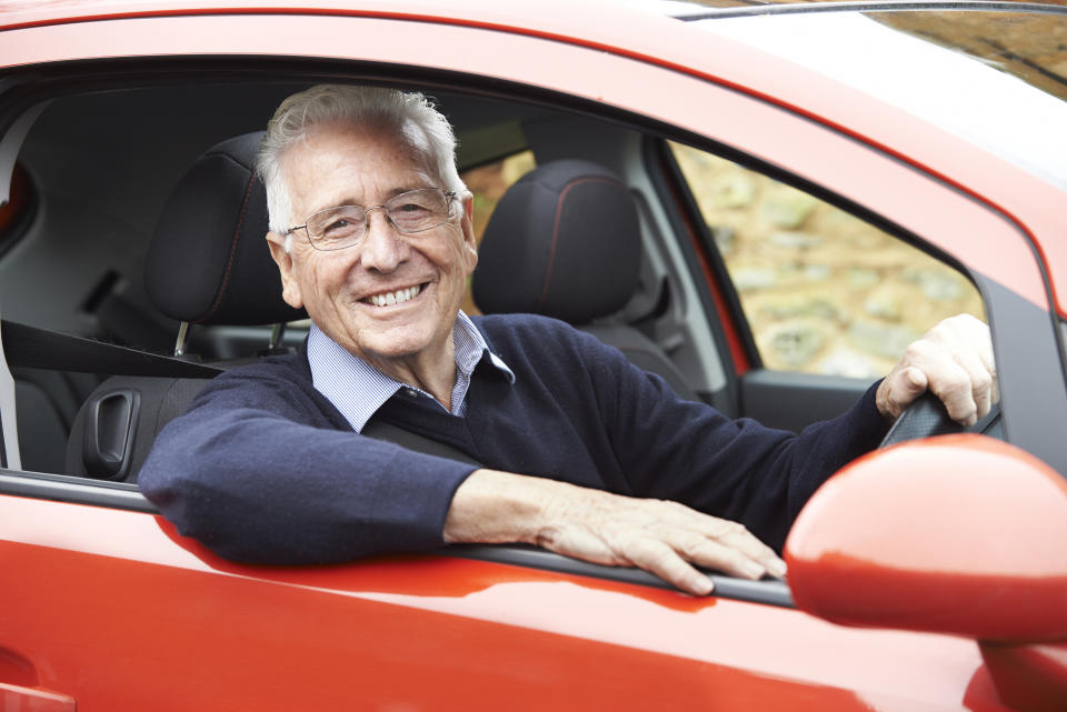 An older man is seen smiling behind the wheel of a car. National Seniors chief advocate Ian Henschke and other experts said a loss of license for the elderly leads to a loss of independence.